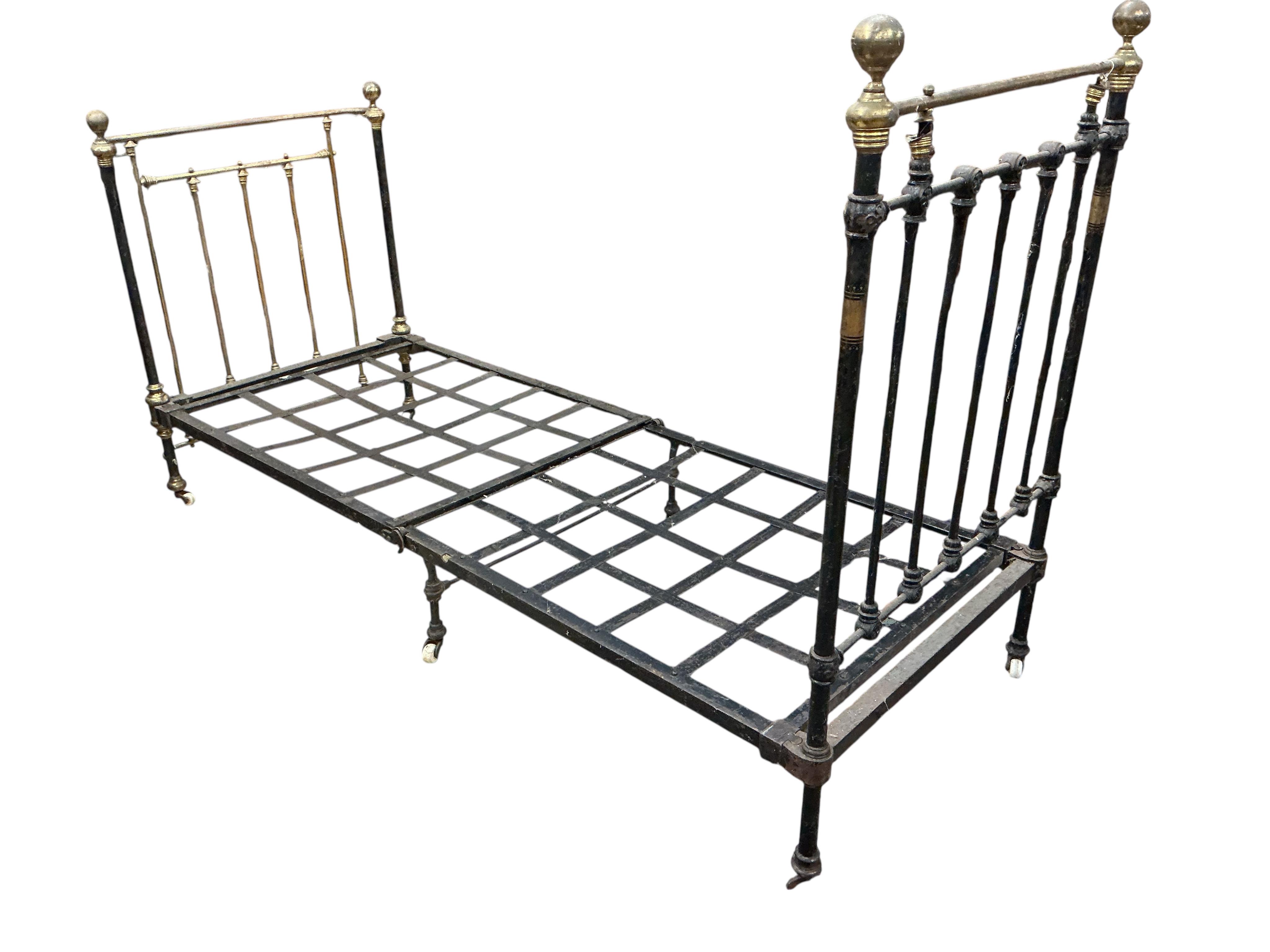 A pair of Victorian brass mounted cast iron single bed frames, each width 91cm, height 142cm